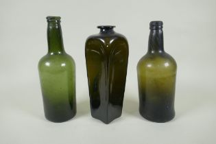 Three C19th green glass wine bottles, 26cm highest