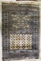 A hand woven wool Middle Eastern prayer rug, signed, 60 x 90cm, and another smaller