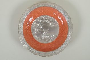 A Chinese salmon pink and silver glazed porcelain dish with lobed rim, with raised deer and crane