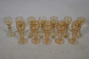 A set of seven C19th amber coloured Hock wine glasses, and five more similar with etched grape and