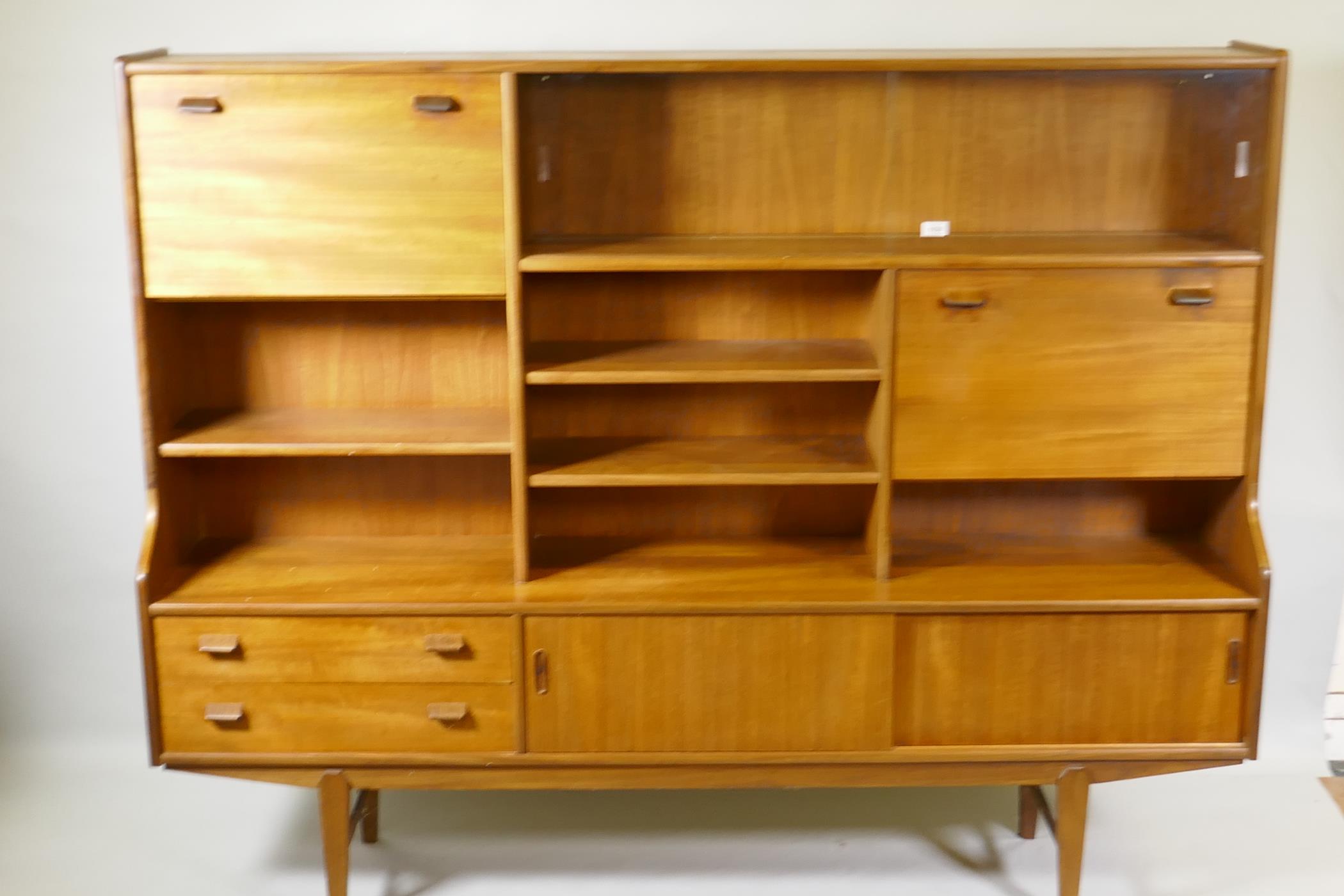 A mid century teak side cabinet with sliding glass doors and open shelves over two drawers and - Image 2 of 3