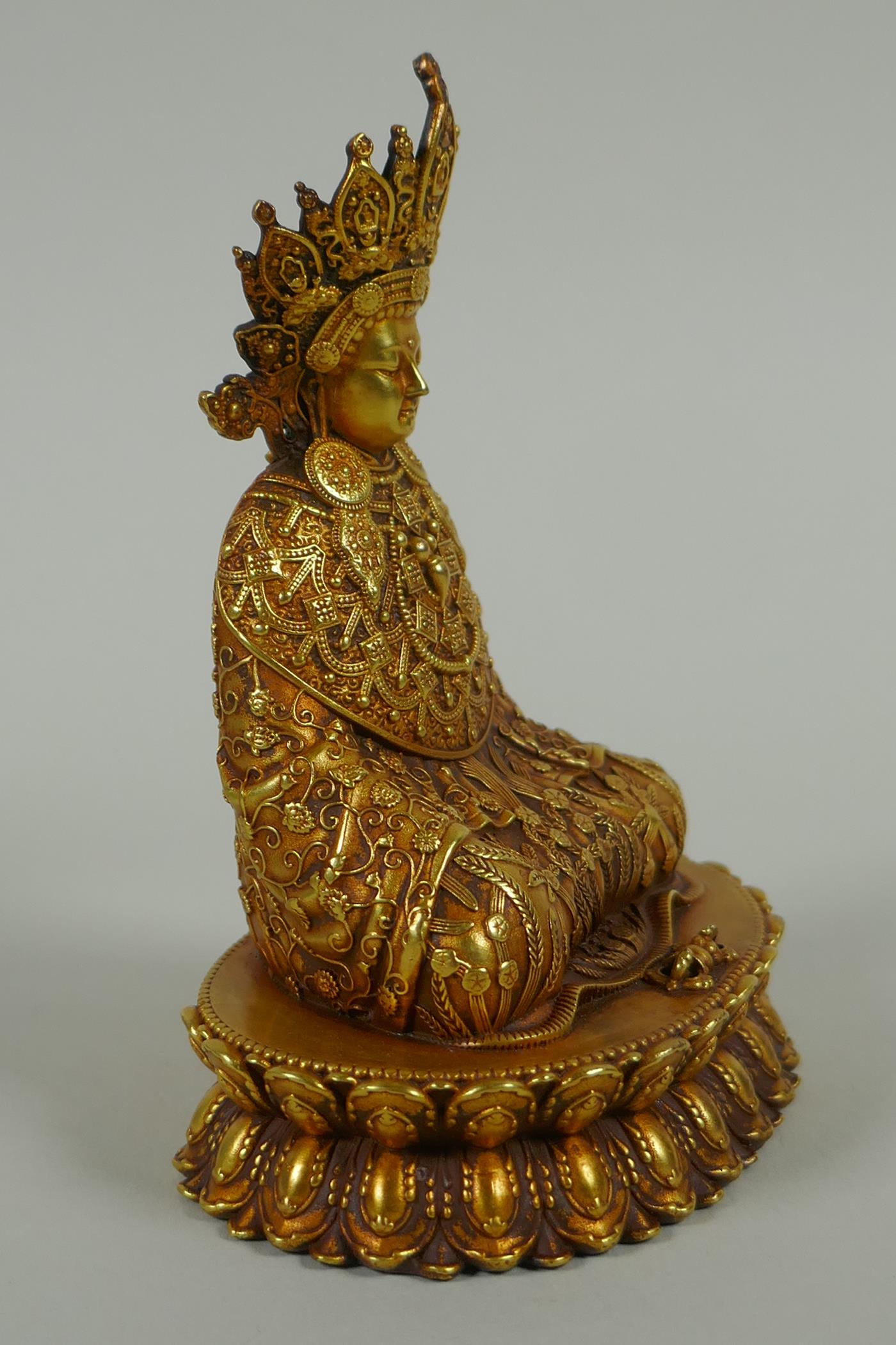 A Sino Tibetan filled gilt bronze Buddha seated on a lotus throne, double vajra mark to base, 11cm - Image 3 of 6