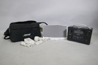 A Bose Sound Dock digital music system, with charger, remote and carry case, and a Roberts sound