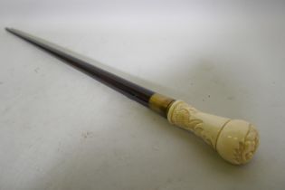 A hardwood walking cane with ivorine handle and mermaid decoration, 88cm long