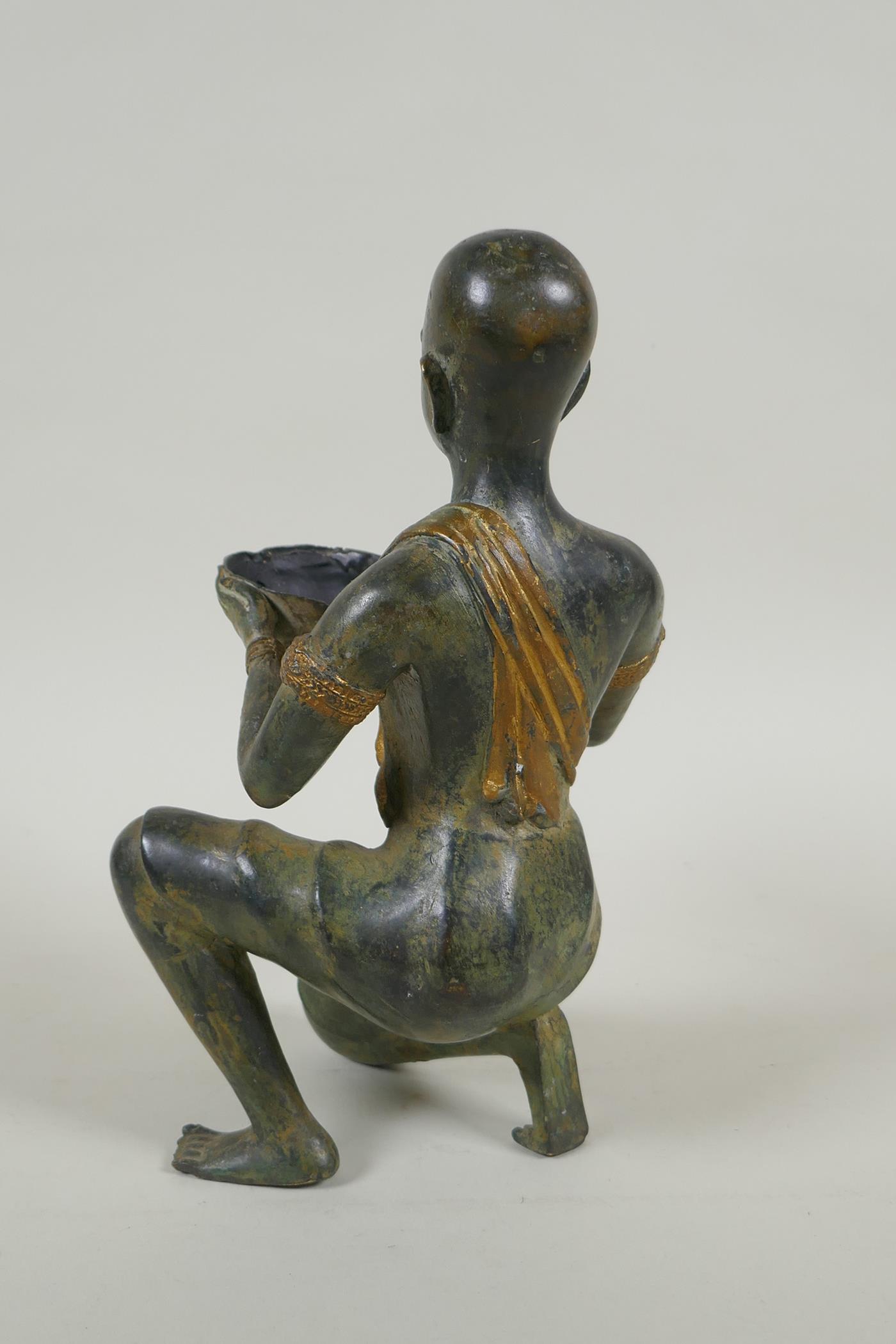 An antique oriental filled bronze figure of a kneeling woman carrying a bowl, 24cm high - Image 3 of 4