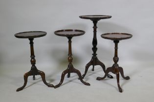 A pair of mahogany wine tables with dished tops, raised on turned columns with tripod supports, 27cm