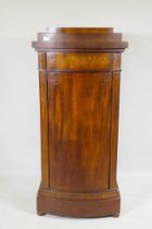 A C19th Danish inlaid mahogany bow fronted cupboard, with single frieze drawer, bears signature of