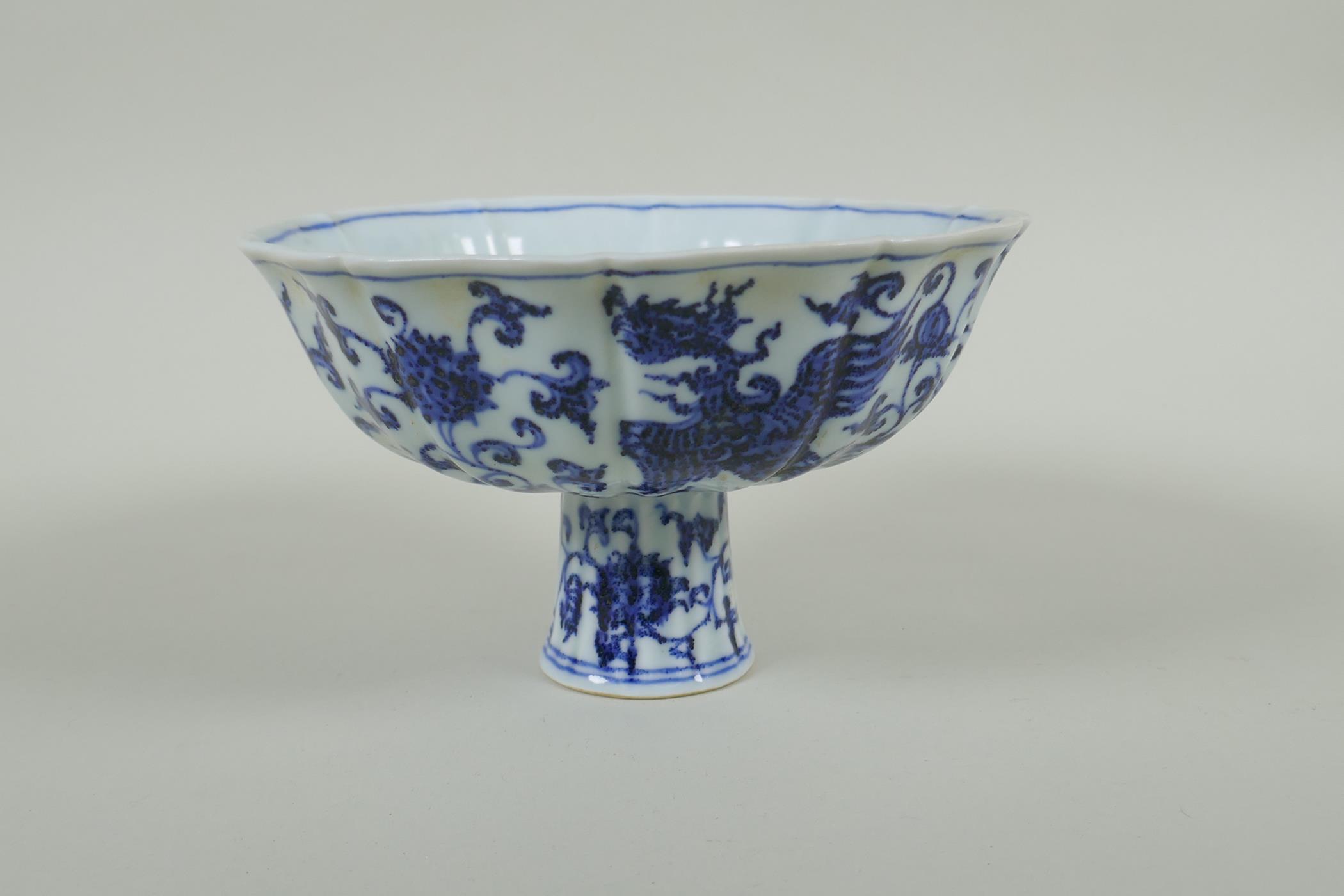 A Chinese blue and white porcelain stem bowl with lobed rim, decorated with phoenix and lotus - Image 2 of 5