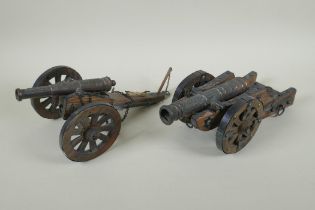 Two wood and metal table canons, 32cm long