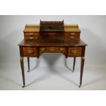 A Victorian inlaid mahogany inverted breakfront bonheure de jour, with pierced brass gallery top and