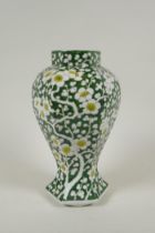 An antique Chinese green ground porcelain baluster vase of hexagonal form, with allover prunus
