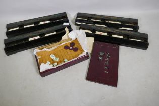 A vintage Mah-Jong set with bamboo and ivorine tiles, and four lacquered counter trays, 41cm long