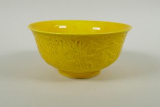 A Chinese yellow ground porcelain bowl with raised dragon decoration, Yong Zheng 6 character mark to