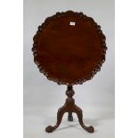 A Georgian style mahogany tilt top occasional table with piecrust top and birdcage movement,