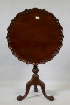 A Georgian style mahogany tilt top occasional table with piecrust top and birdcage movement,