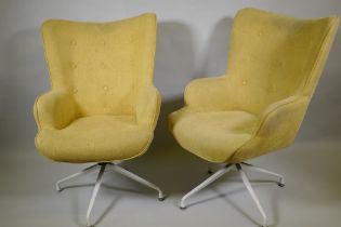 A pair of reclining swivel armchairs on spider legs