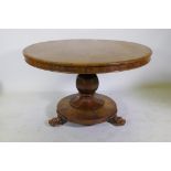 A C19th rosewood tilt top breakfast table, raised on a shaped column with carved detail and platform