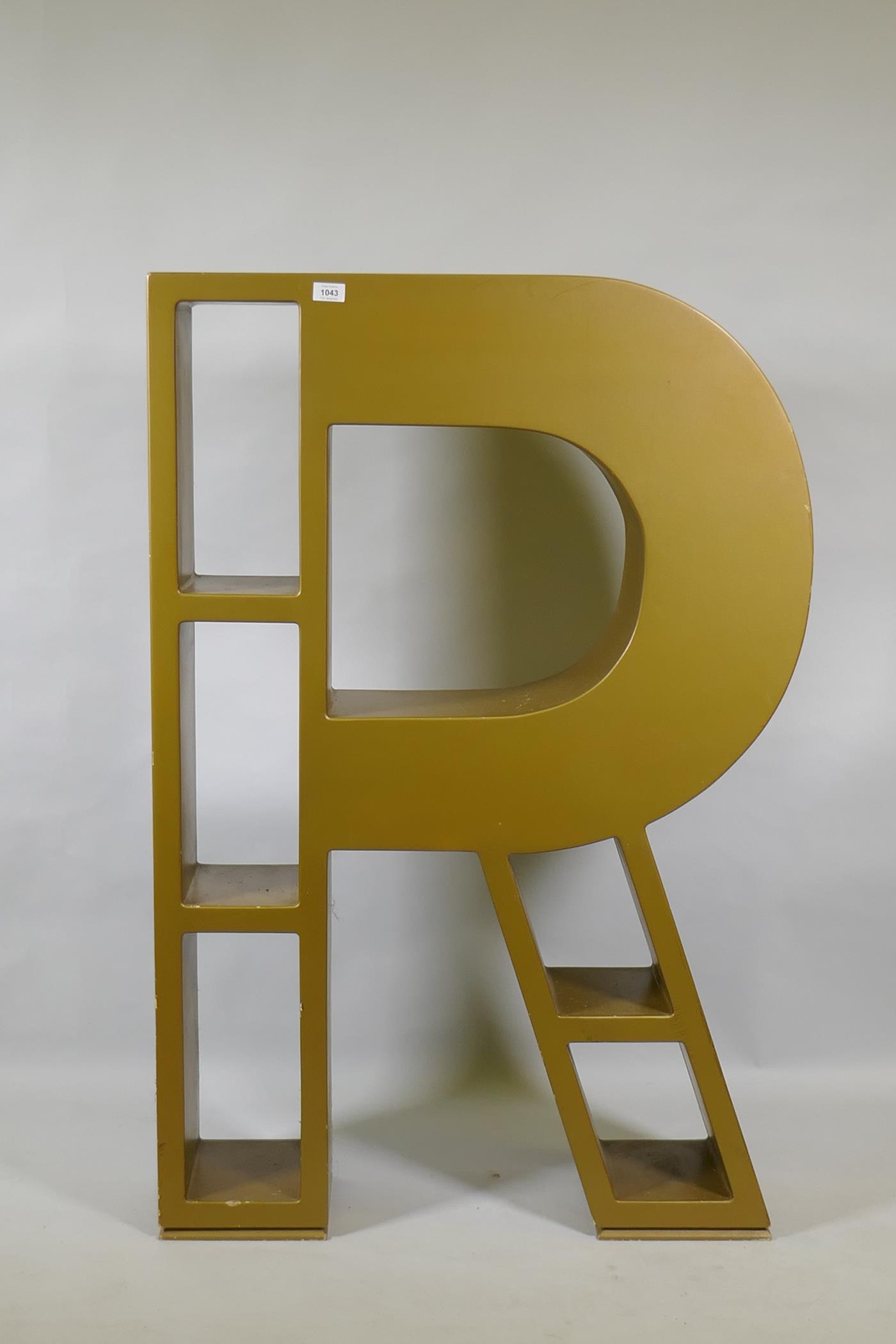 A bespoke painted wood bookcase in the shape of the letter R, 83 x 24cm, 120cm high