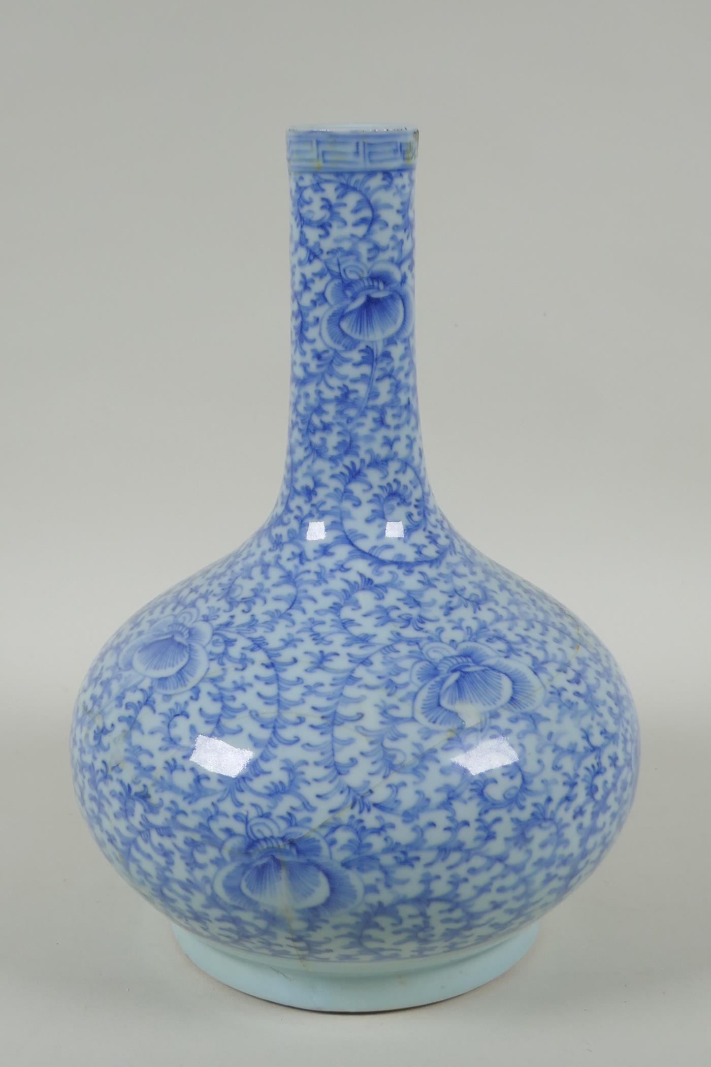 A C19th Chinese blue and white porcelain bottle vase with scrolling floral decoration, AF repair, - Image 2 of 6