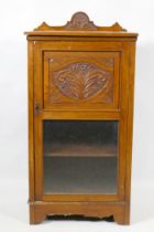 A Victorian walnut music cabinet with carved back and door, 50 x 34 x 99cm