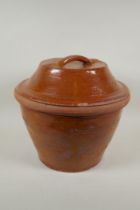 An antique glazed terracotta bread crock pot, 34cm high, 36cm diameter