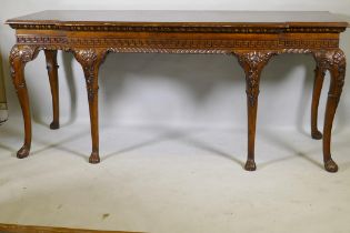 A pair of Georgian style mahogany breakfront serving tables, with key pattern frieze and carved