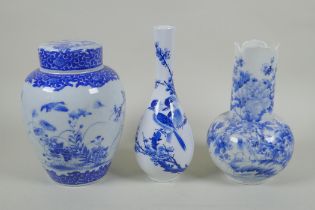 Two Japanese Meiji period blue and white porcelain vases decorated with birds amongst flowers and