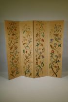 An antique Arts & Crafts style four fold screen, with embroidered crewel work designs of flowers and