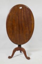 A Victorian mahogany tilt top occasional table, raised on turned column and tripod supports, 54 x 75