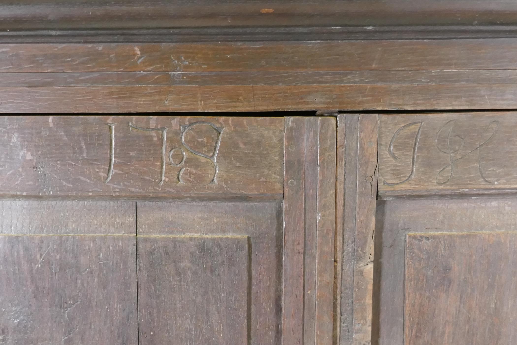 An early C18th two door cupboard with fielded panel doors and panelled sides, raised on a plinth - Image 3 of 5