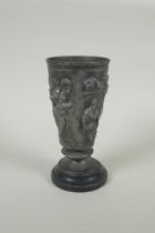 An antique French Grand Tour pewter goblet on a slate socle, with raised Greco Roman figural