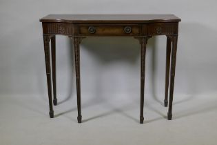 An Adam style mahogany breakfront side table with single drawer and carved fluted frieze, raised