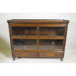 A Globe Wernicke style oak bookcase, two sections on a base of two drawers, raised on cabriole