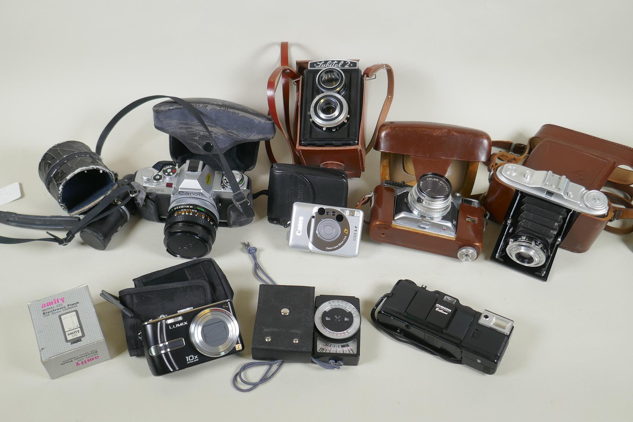 A quantity of vintage 35mm and medium format cameras and accessories, to include a Canon AV-1, a