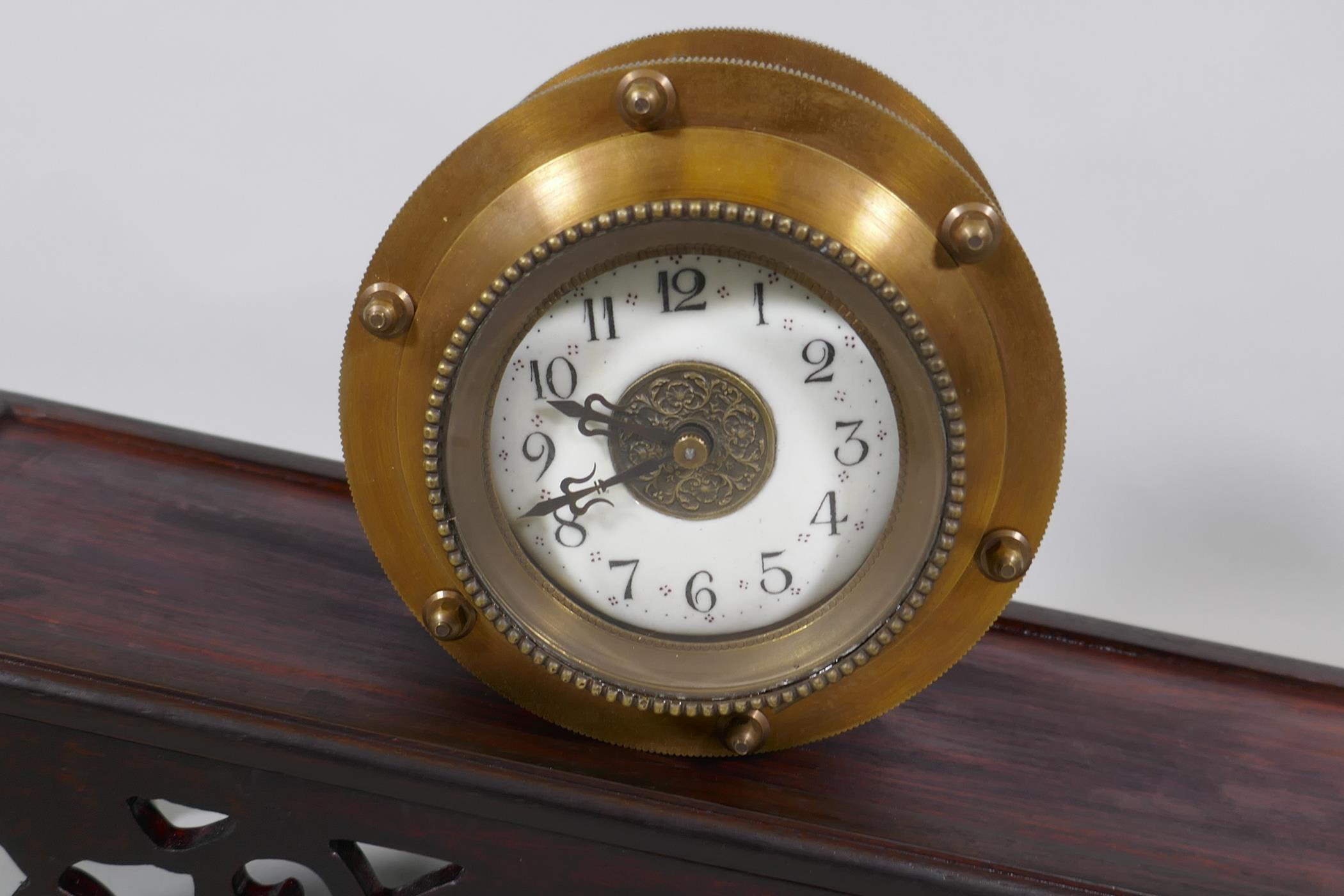 A brass cased gravity driven incline rolling clock with enamel dial and Arabic numerals, standing on - Image 2 of 3