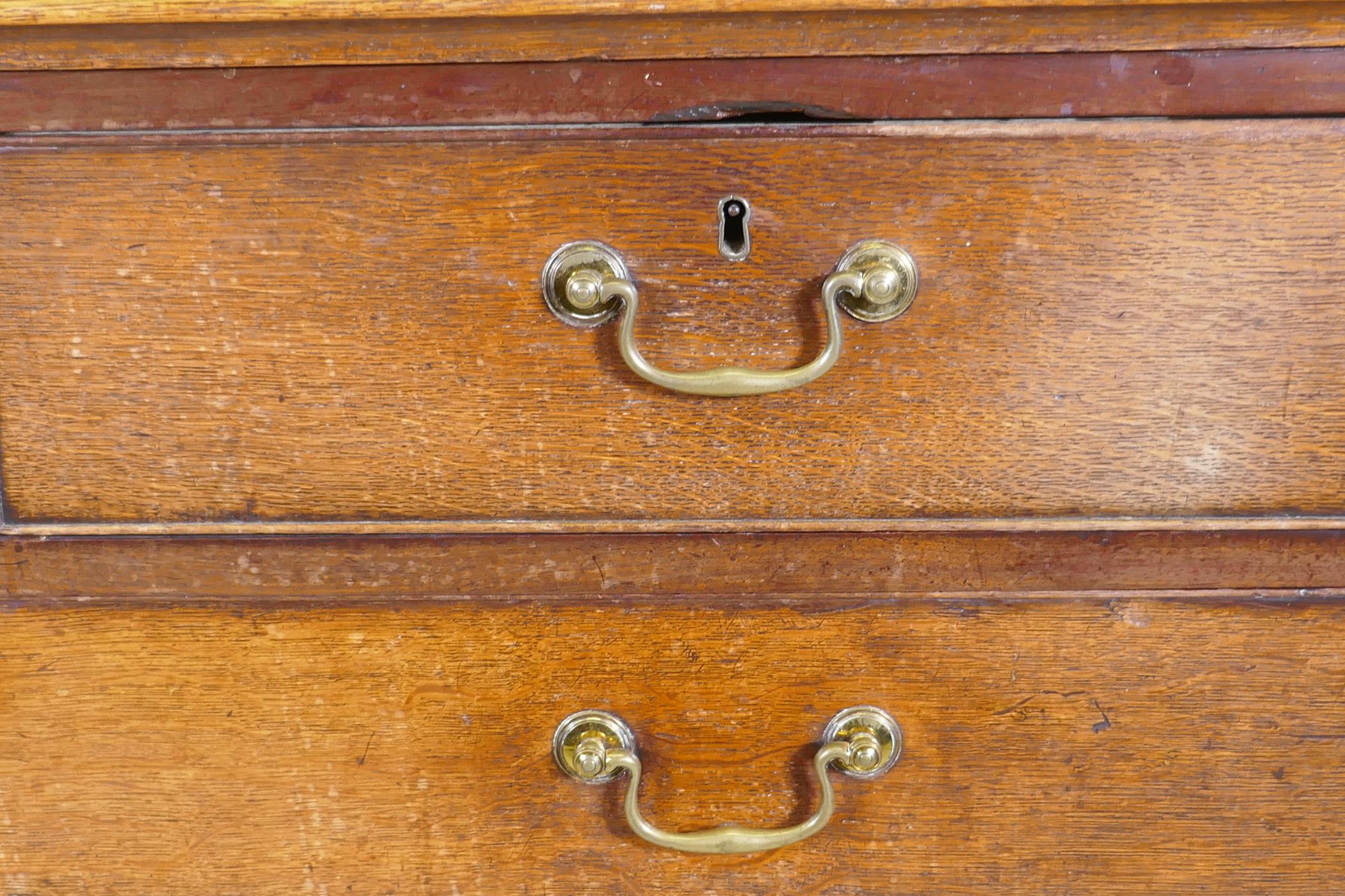 A Georgian oak chest of two over three drawers, mahogany banded top, cockbeaded drawers with - Image 2 of 7
