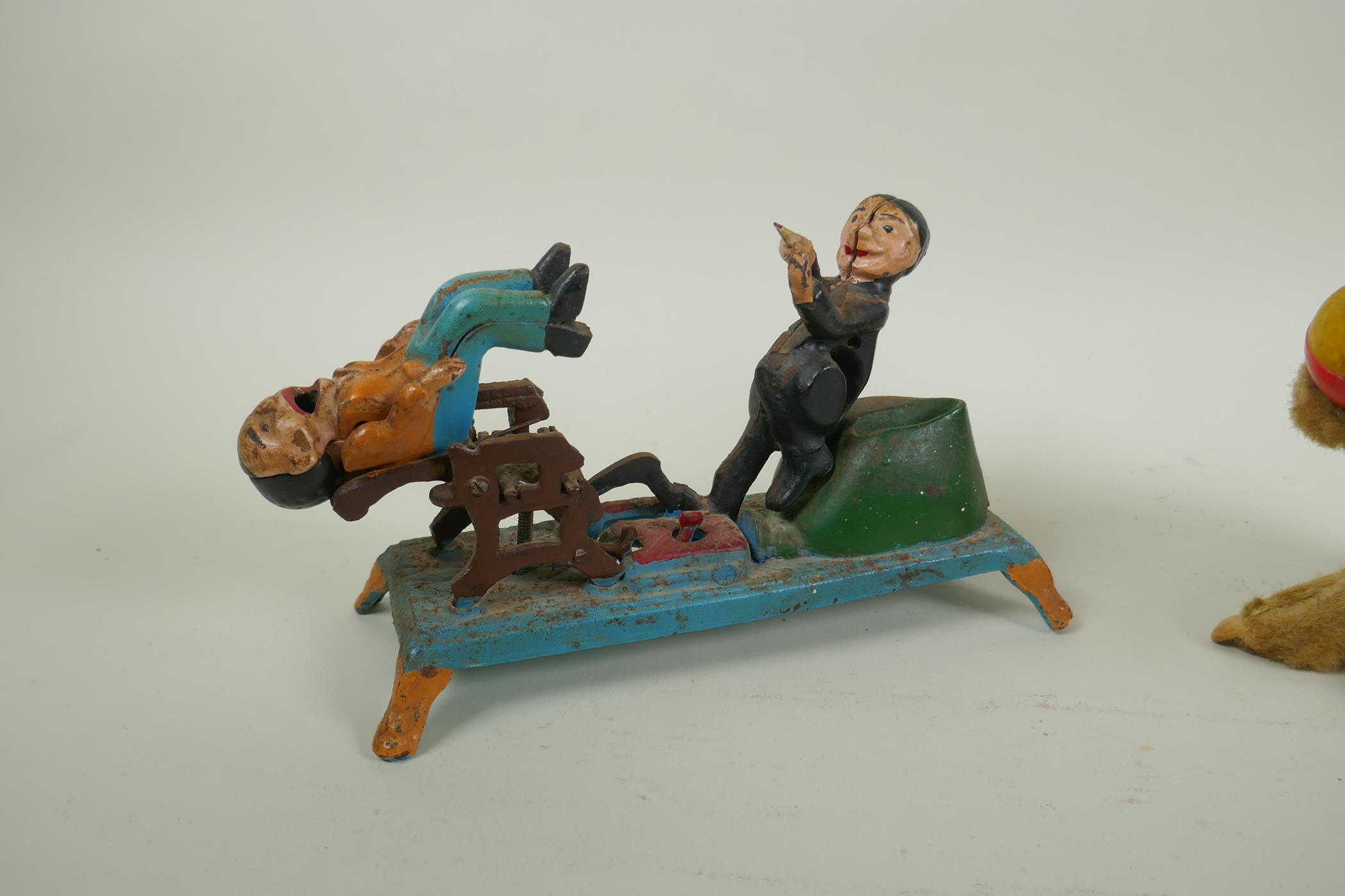 A painted cast iron money box in the form of a dentist, 22cm long, and a vintage clockwork money - Image 3 of 4