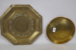 An antique Indian brass tray with lion and elephant decoration, 76cm diameter and another smaller