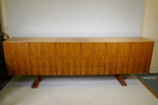 A mid century Danish style rosewood sideboard, with six cupboards over six drawers, the interior