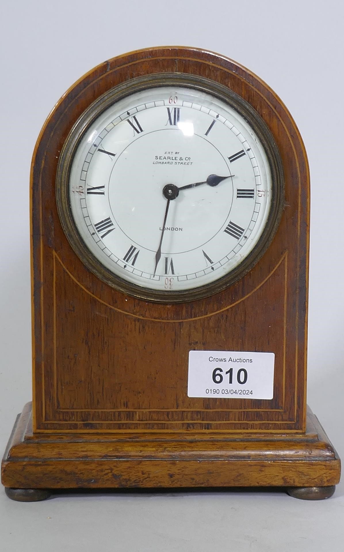 An Edwardian mahogany dome cased mantel clock, the enamel dial with Roman numerals inscribed