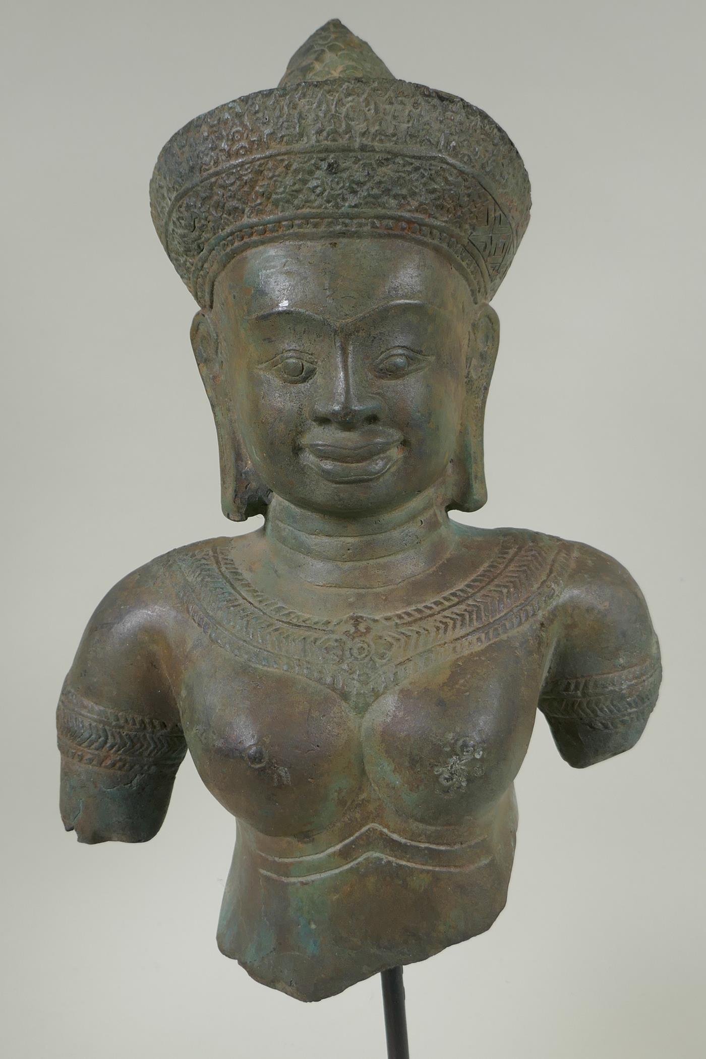 A Cambodian bronze bust of a female deity, on a display stand, 44cm high - Image 2 of 2