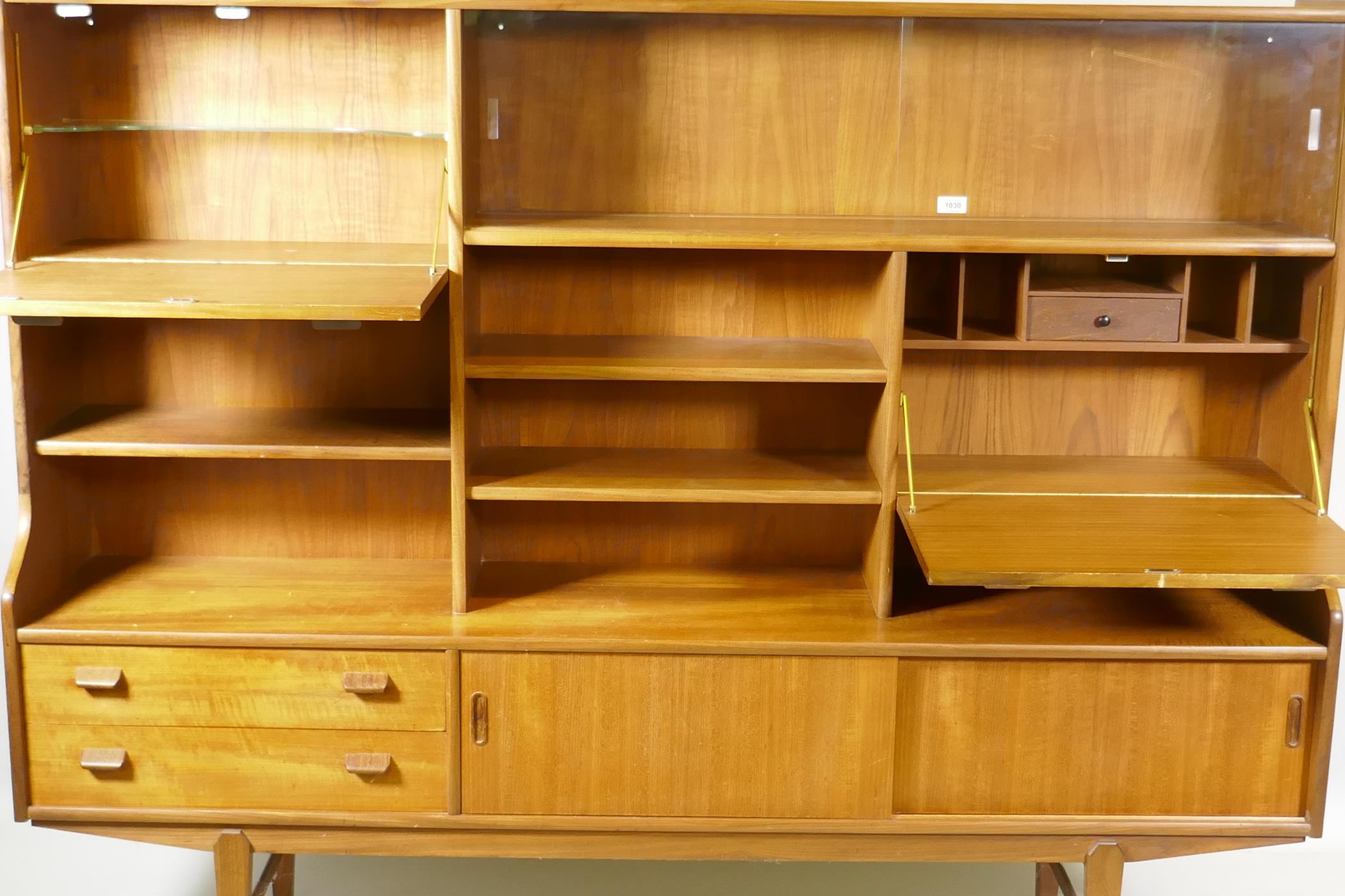 A mid century teak side cabinet with sliding glass doors and open shelves over two drawers and - Image 3 of 3