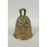 An antique pierced bronze prayer bell decorated with depictions of angelic musicians and Catholic