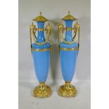 A large pair of Sevres blue style ceramic urns with ormolu mounts, 135cm high