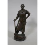Antique bronze figure of a blacksmith with hammer, unsigned, on a slate base, 26cm high