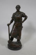 Antique bronze figure of a blacksmith with hammer, unsigned, on a slate base, 26cm high