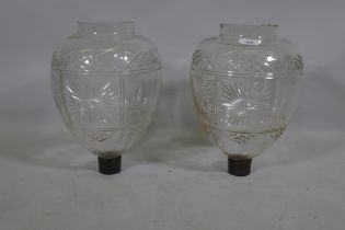 A pair of antique cut glass spirit optics with brass mounts, 38cm high