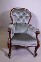 A Victorian spoon back walnut armchair, raised on cabriole support, back legs AF