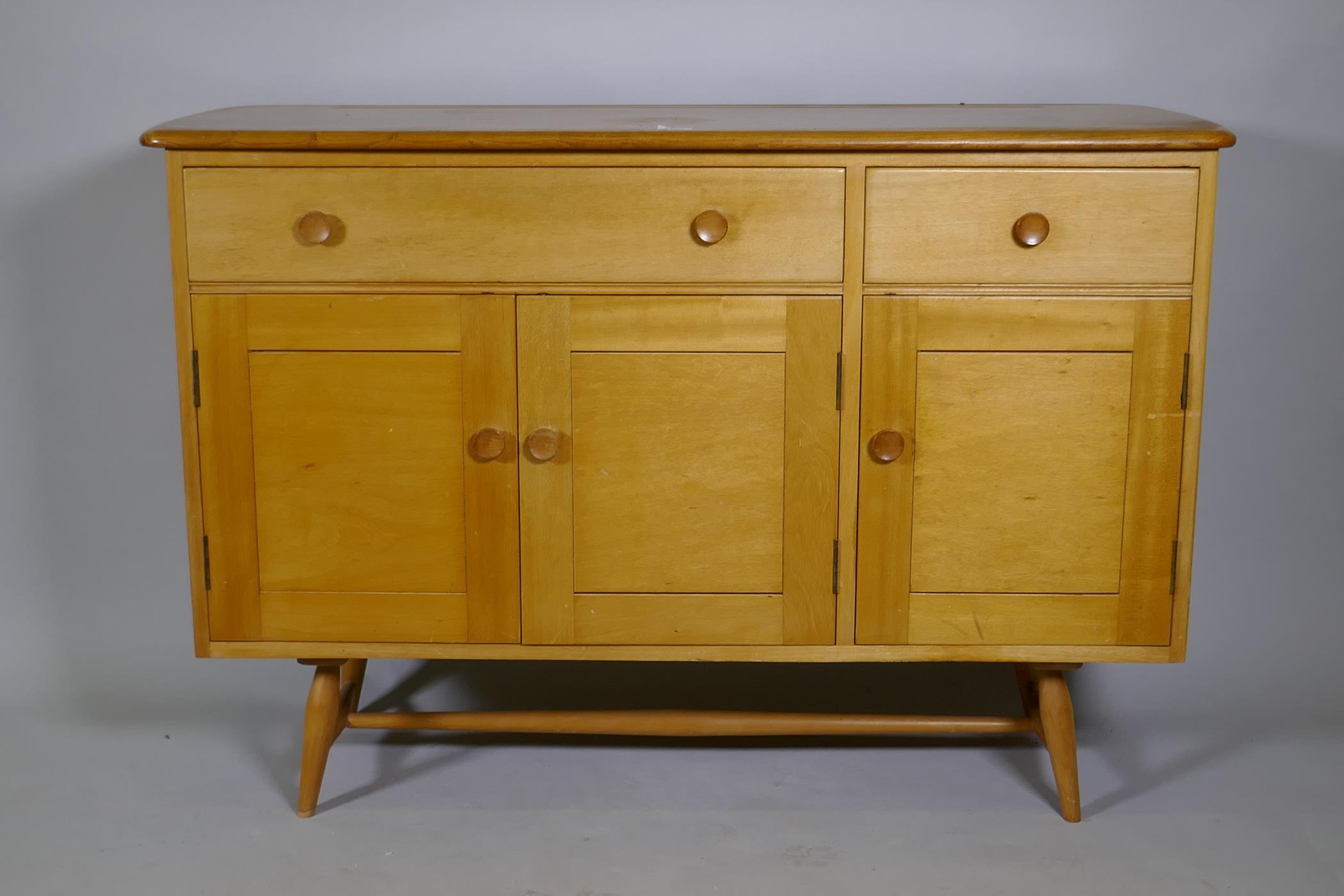 An Ercol Model 351 beech and elm top sideboard, with two drawers, one fitted with cutlery slide,