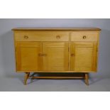 An Ercol Model 351 beech and elm top sideboard, with two drawers, one fitted with cutlery slide,